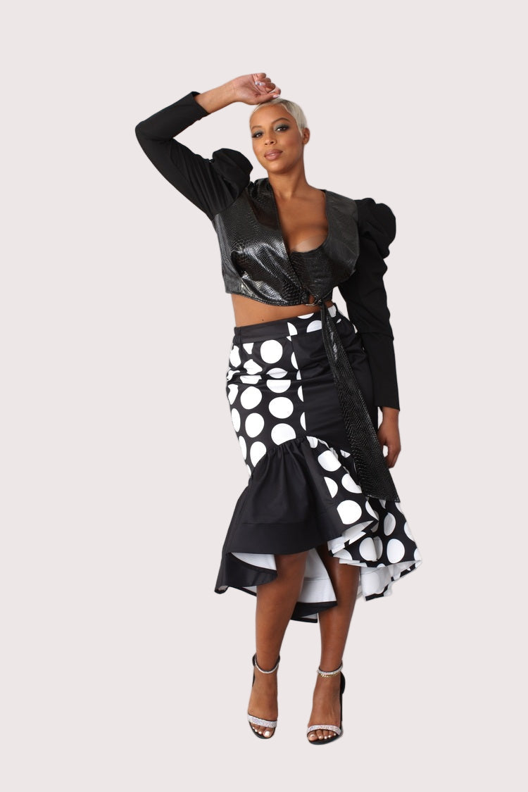 Black and white dotted high low skirt front view with dramatic hem detail.