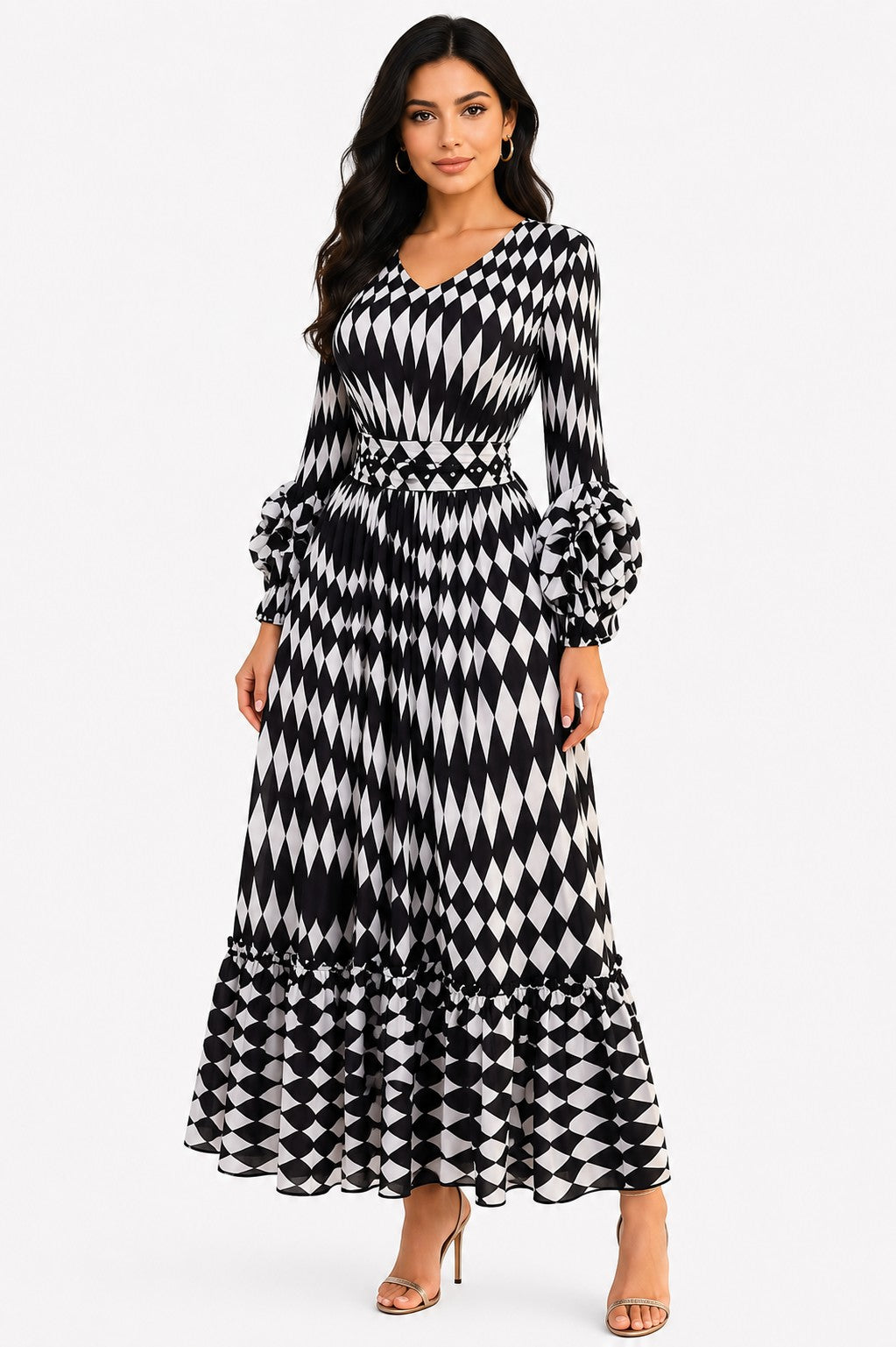Model wearing the Printed Tiered Pleated Maxi Dress in White and Black featuring an abstract print, flowing pleated tiers, long sleeves, and a flattering maxi silhouette by For Her NYC White/Black