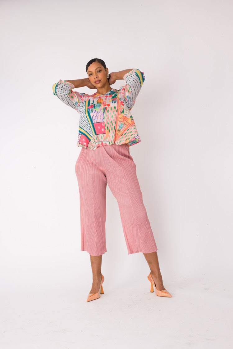 Model wearing the Printed Top and Palazzo Pants Set in pink multi, front view with relaxed pose highlighting the abstract print top and pleated wide-leg palazzo pants, For Her NYC