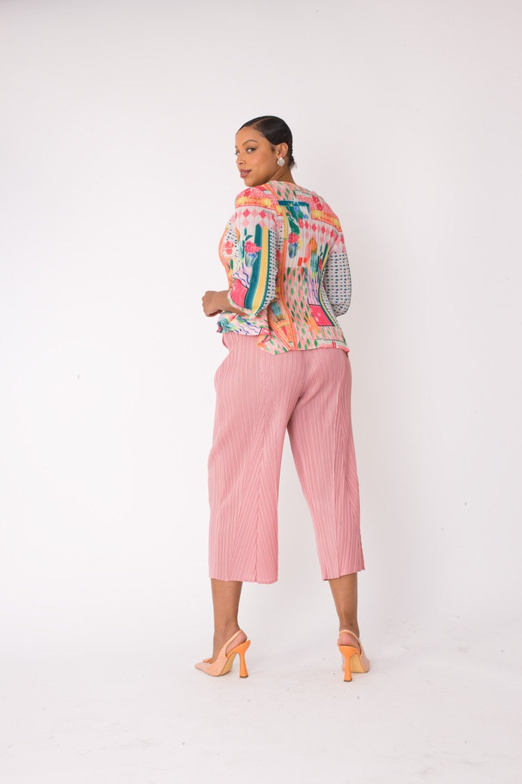 Model wearing the Printed Top and Palazzo Pants Set in pink multi, side view with turned-back pose highlighting the abstract print top and pleated wide-leg palazzo pants, For Her NYC