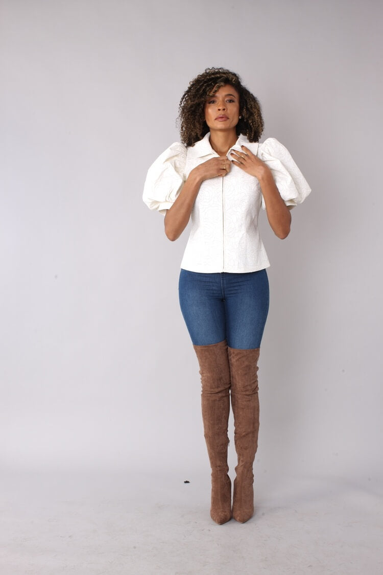 White puff sleeve faux leather jacket front view with model lifting arms to showcase sleeve volume by For Her NYC