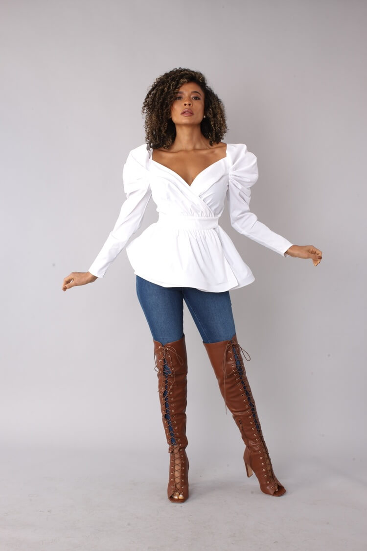 Side stepping view of white puff sleeve wrap peplum top – For Her NYC