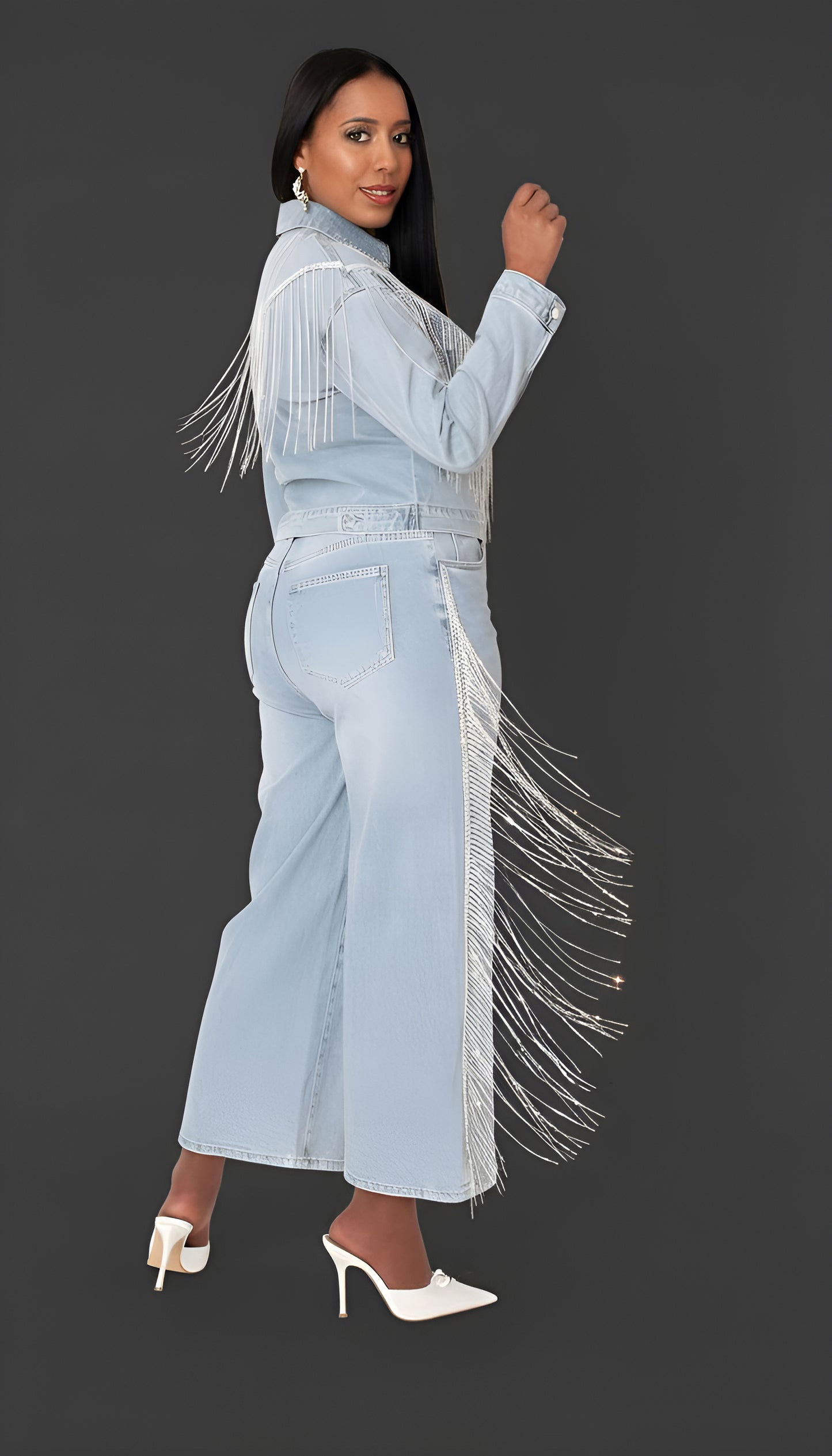 Wash blue denim rhinestone fringe jean with sparkling side fringe detail, side view highlighting movement and silhouette by For Her NYC
