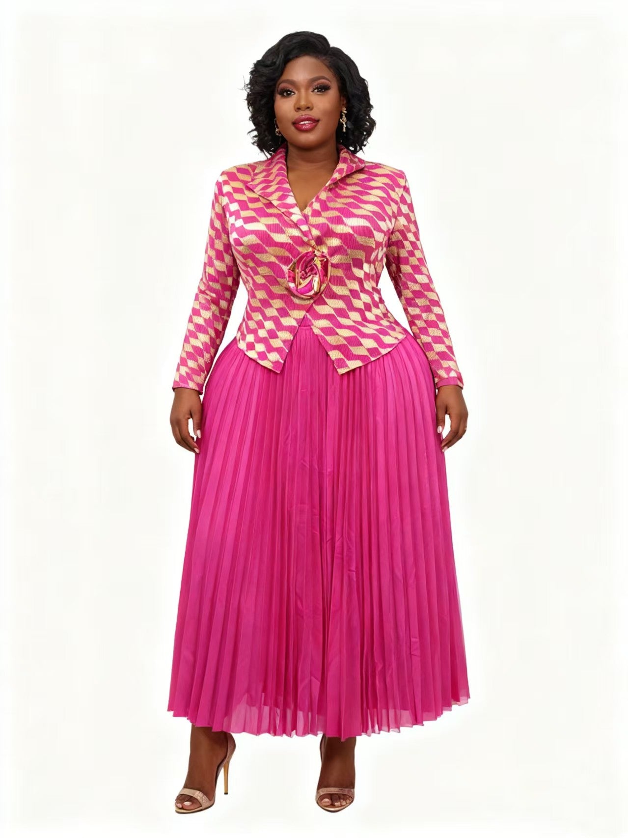 Pink multi rhombus pleated skirt suit with tailored patterned jacket and pleated skirt, model standing front, For Her NYC