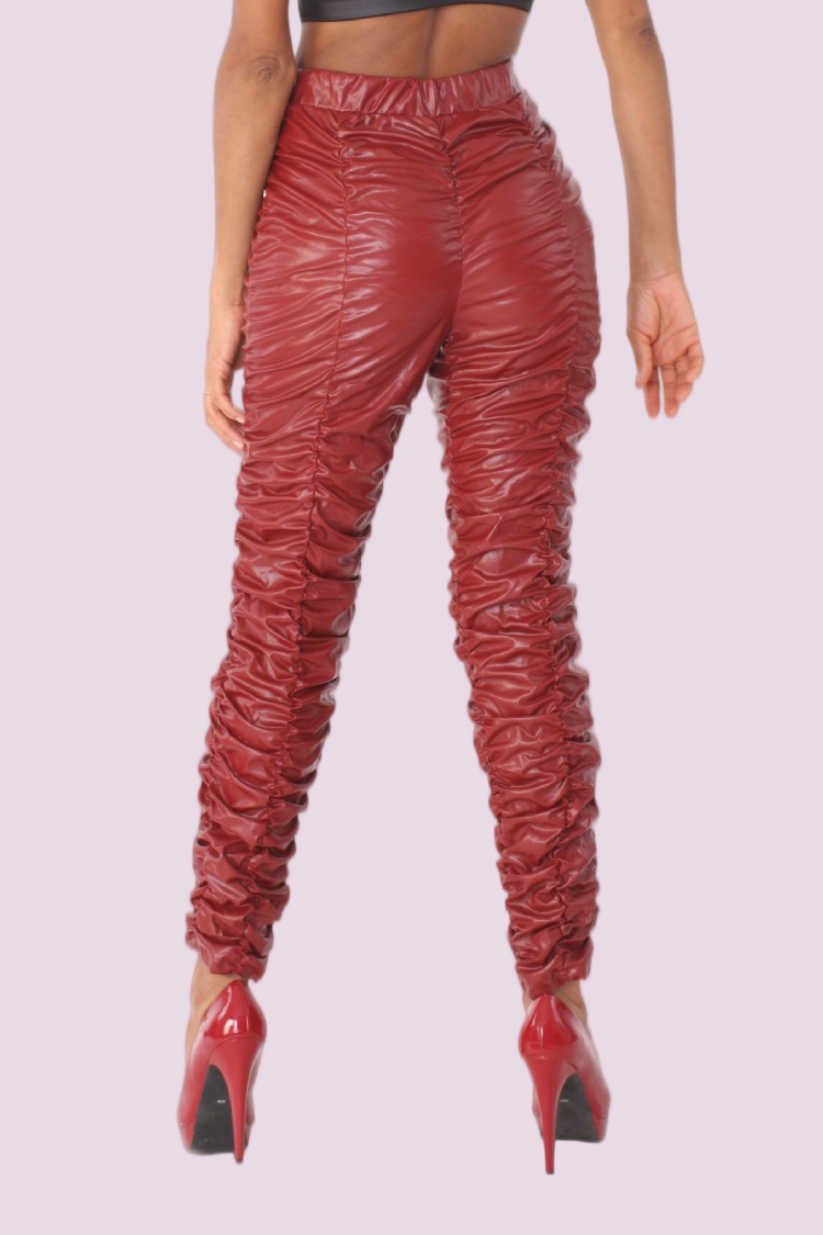Detail view of red ruched faux leather high-rise pants highlighting textured leg design and high-rise silhouette by For Her NYC