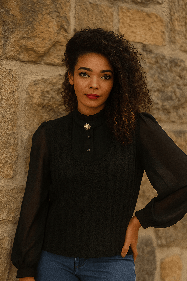 Black ruffled puff sleeve blouse with lace detail, front pose.