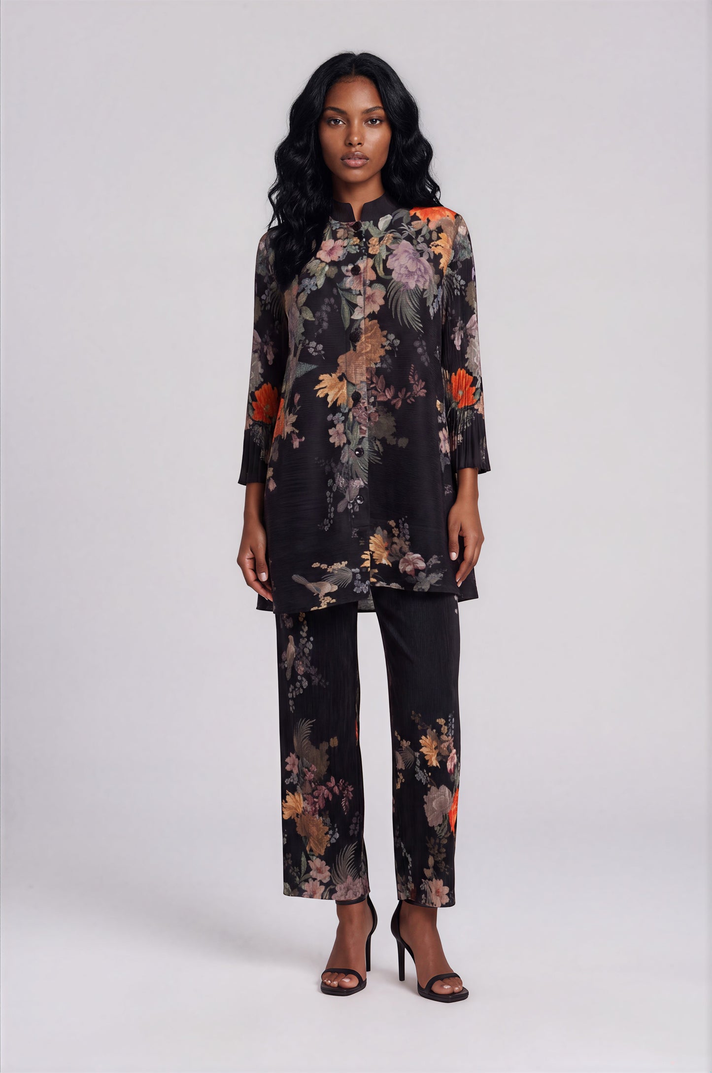 For Her NYC Spring Garden Print Tunic Pant Set in Black Multi featuring a vibrant floral print, button-front long tunic, coordinating straight-leg pants, and an elegant two-piece silhouette.