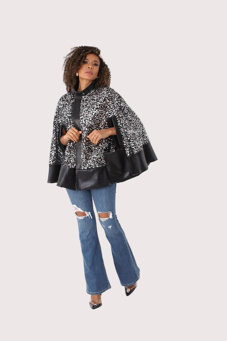 Right angled view of black sequin cape with faux leather trim — For Her NYC.