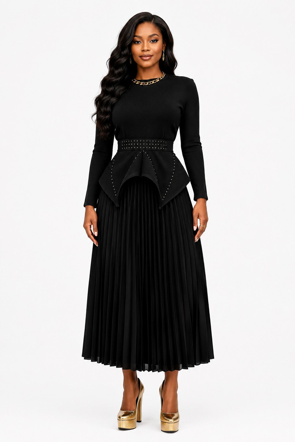 Model wearing the Black Studded Peplum Pleated Skirt Set featuring a structured peplum top with subtle stud detailing, long sleeves, and a flowing pleated midi skirt by For Her NYC.