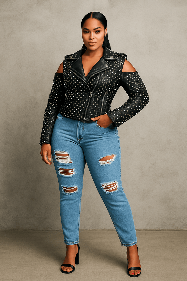 Black studded pleather moto jacket with open shoulder cutouts shown from the front, featuring an edgy fitted silhouette styled with distressed denim by For Her NYC