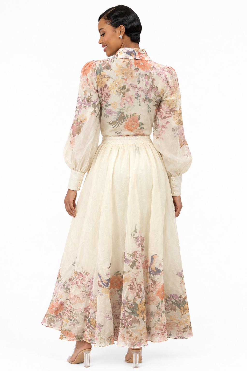 Model showing the back of the Tally Taylor Floral Print Blouse & Maxi Skirt Set in multicolor floral print, long sleeves and a flowing maxi skirt, style S0095.