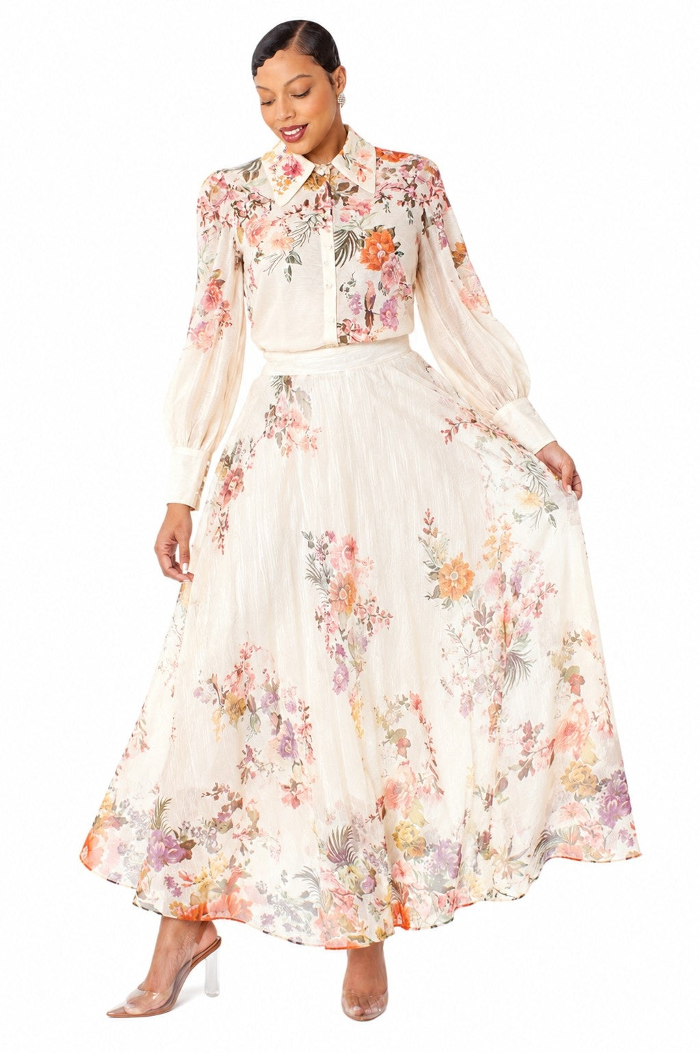 Model wearing the Tally Taylor Floral Print Blouse & Maxi Skirt Set in with multicolor floral print, long sleeves and a flowing maxi skirt, style S0095.