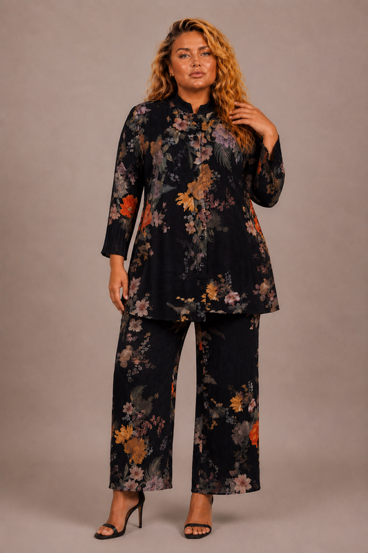 Plus size model wearing the Tally Taylor Spring Garden Print Tunic Pant Set in black with multicolor floral print, button-front tunic and matching pants, style S0105W.