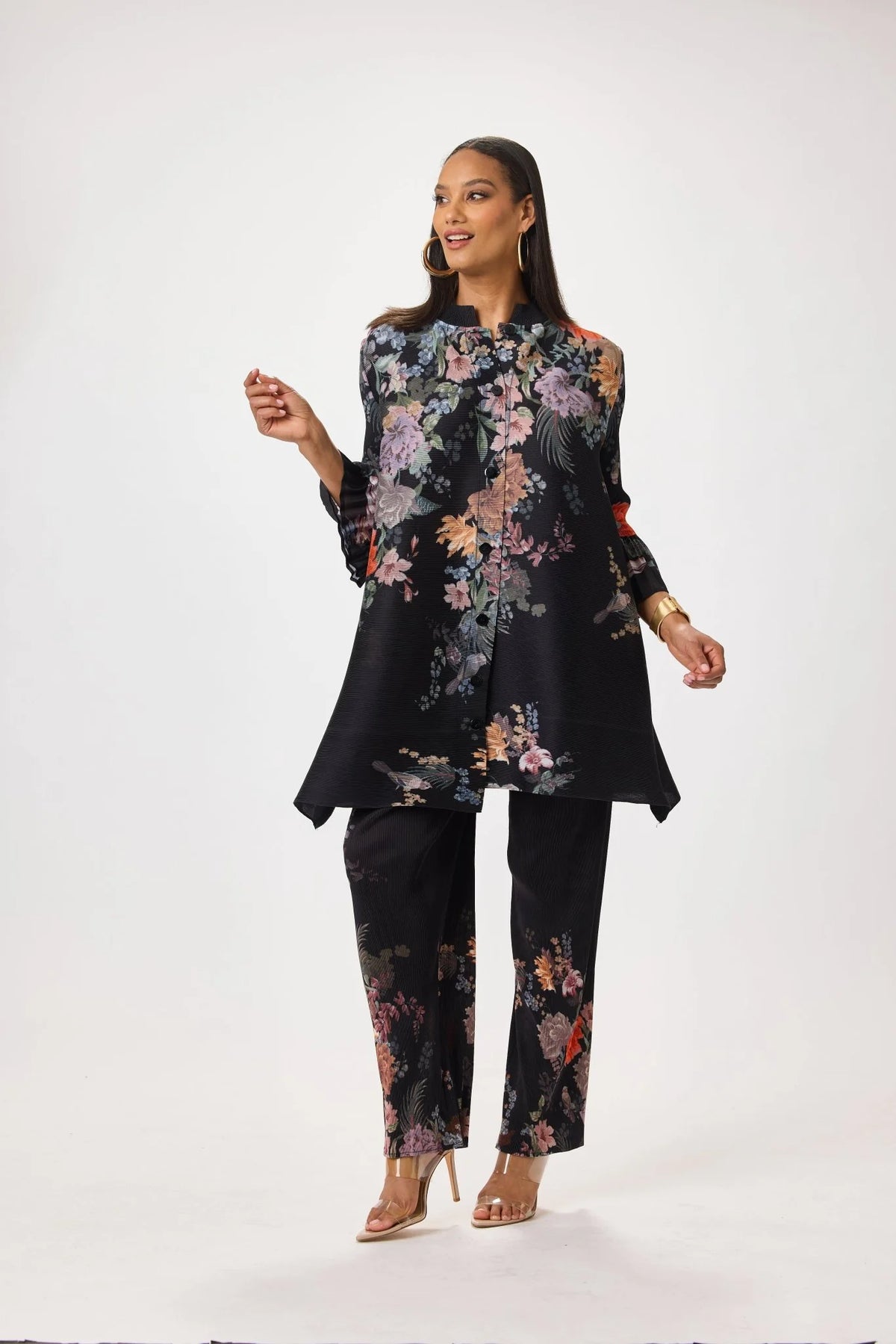 Model wearing the Tally Taylor Spring Garden Print Tunic Pant Set featuring a black multicolor floral tunic with matching printed pants, style S0105.