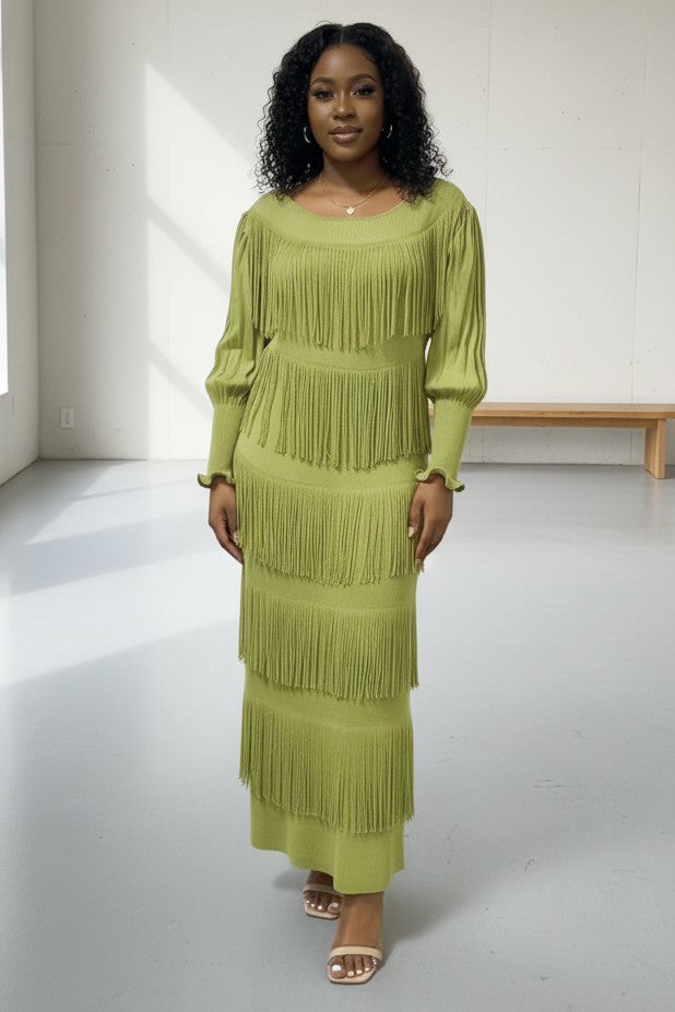 Front view of model wearing green tiered fringe knit midi dress with long sleeves and layered fringe detail, For Her NYC