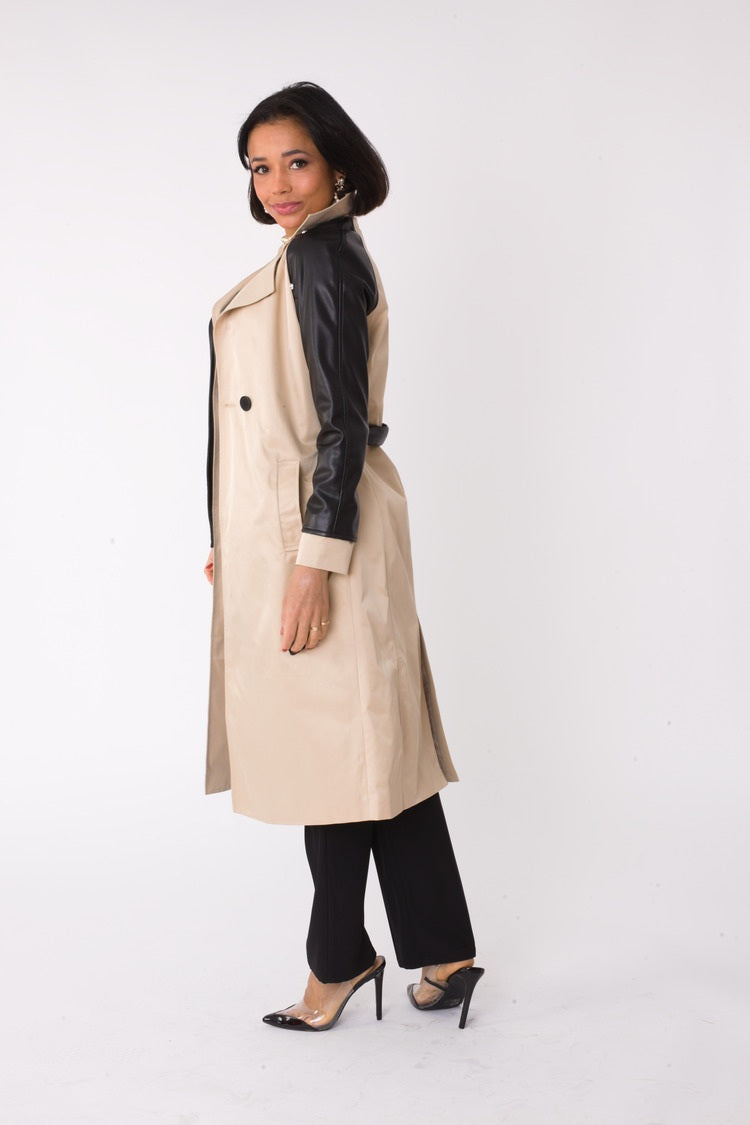 Back view of model wearing the khaki and black two tone leather sleeve trench coat showing clean back design and knee length hem by For Her NYC