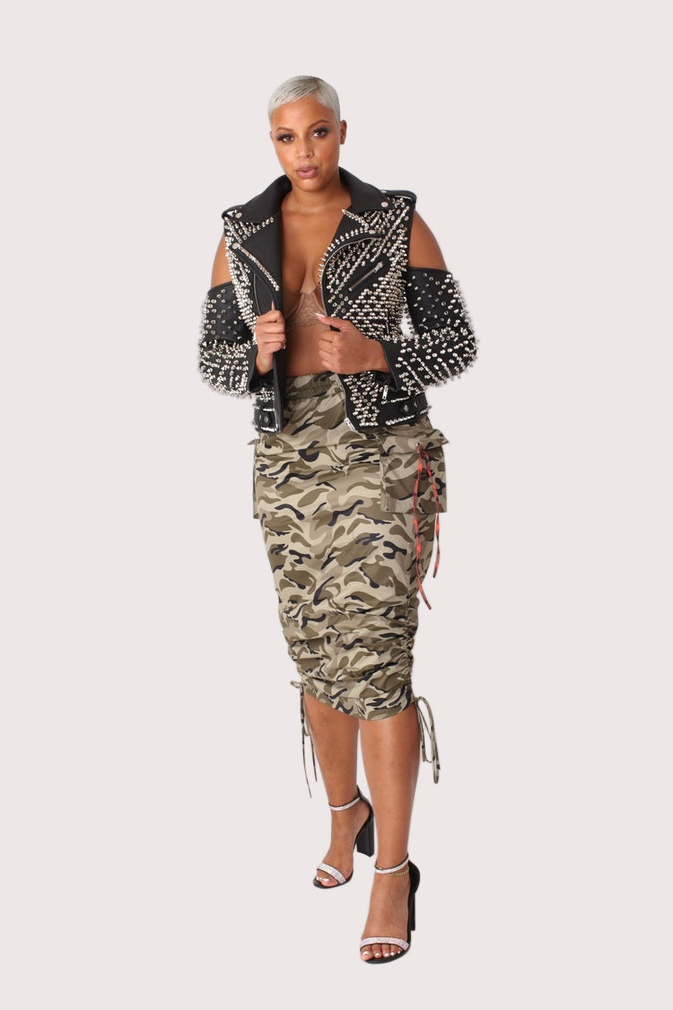 Model wearing a camouflage woven midi skirt in a front standing pose, highlighting the ruched waist and slim, figure-skimming silhouette, For Her NYC