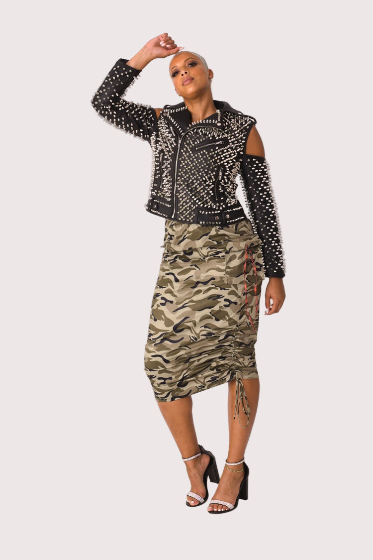 Model wearing a camouflage woven midi skirt in a front walking pose, showing natural movement and the bold camo pattern, For Her NYC