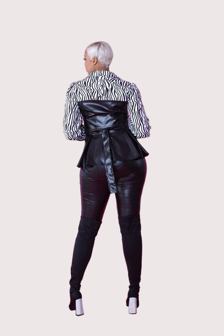 Back view of black and white zebra print peplum top with faux leather bodice – For Her NYC